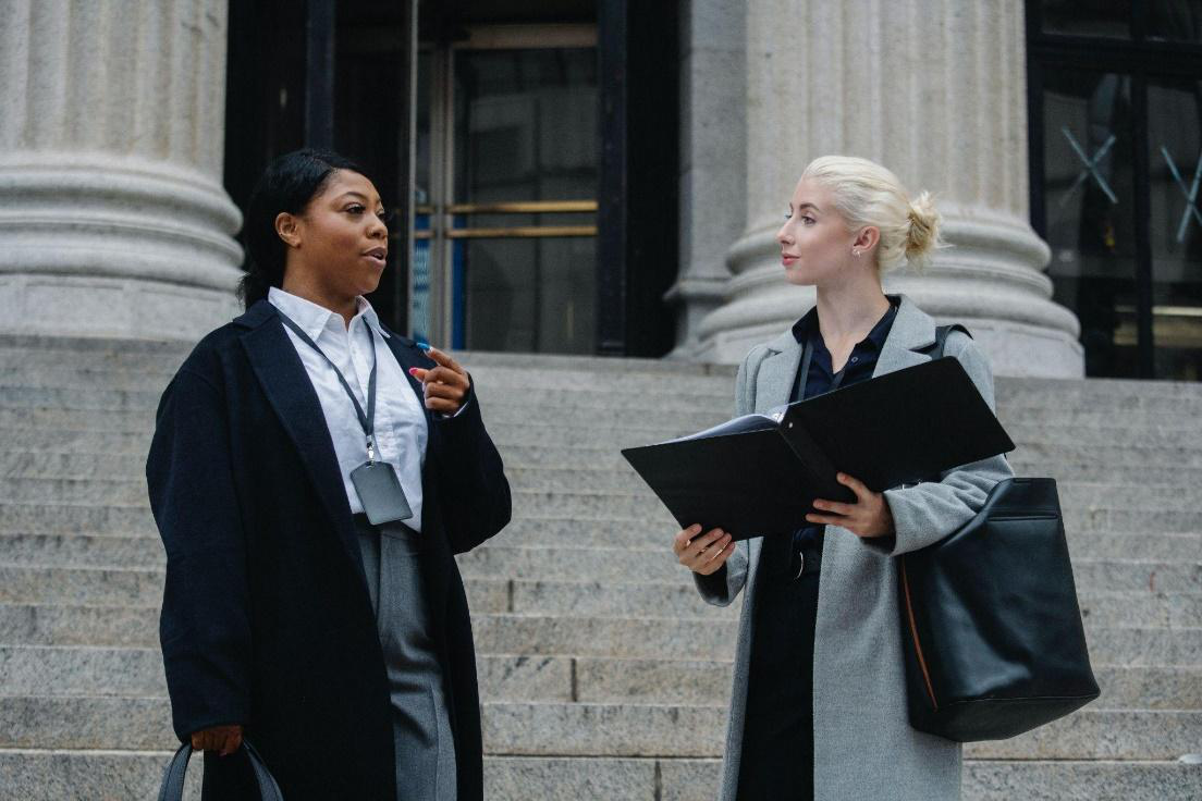 Two lawyers talking outside court