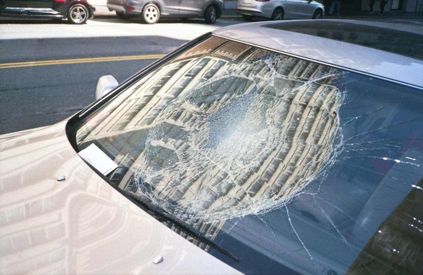  Close-up of a smashed car windscreen on a white car