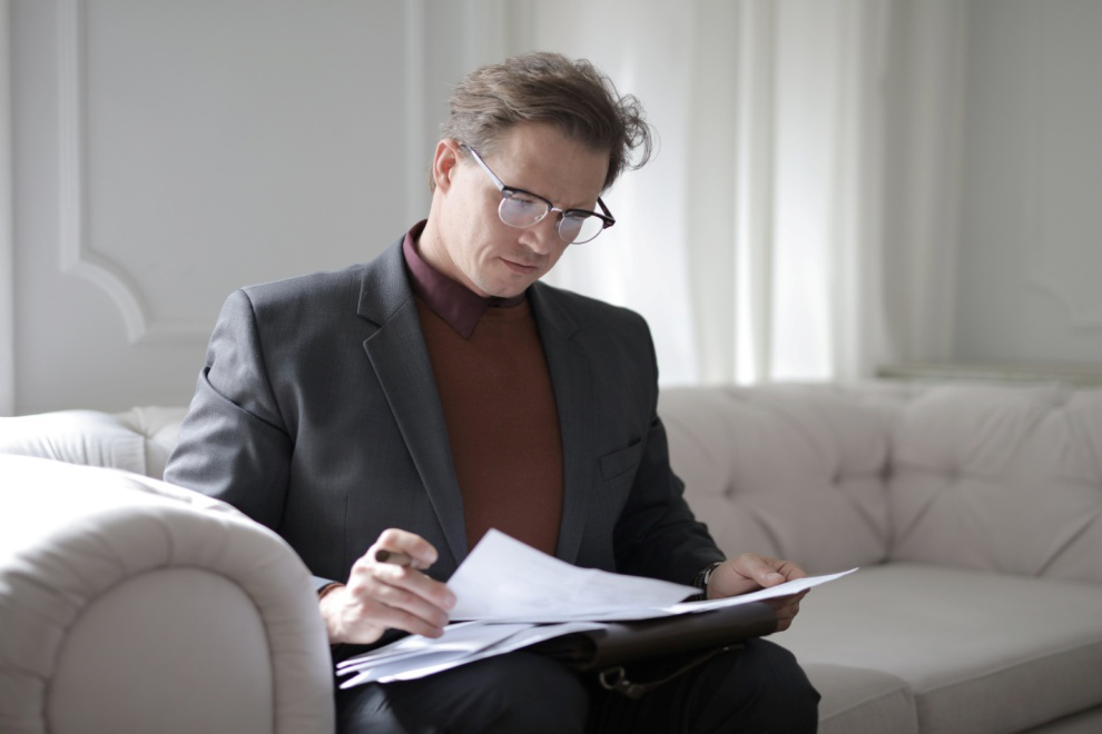 Man in formal attire reading documents