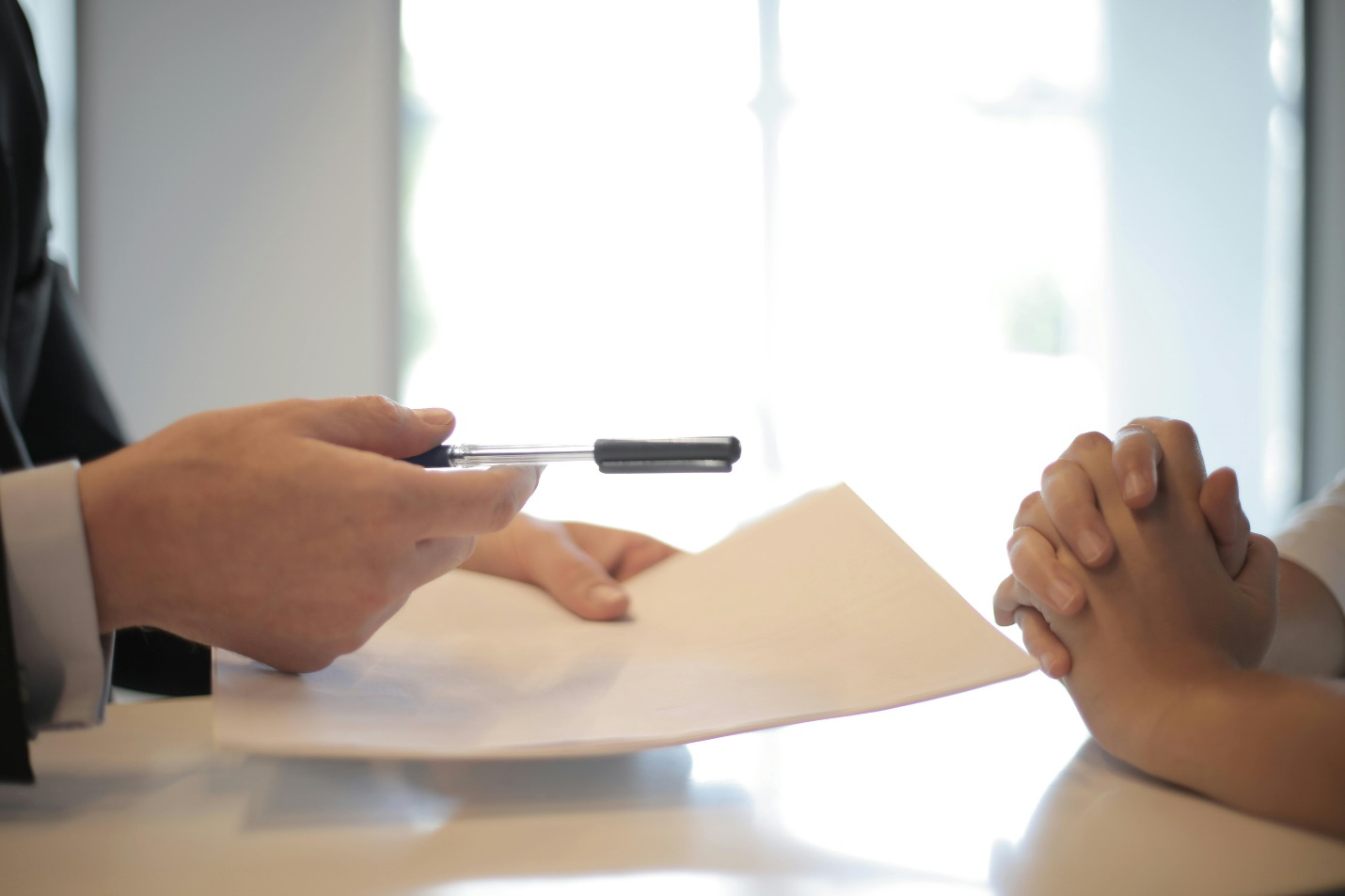 a person giving document papers to sign