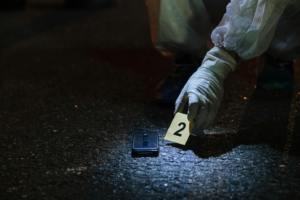 a person placing a number tag next to a phone on the floor