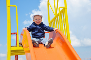 a kid sitting on a slide