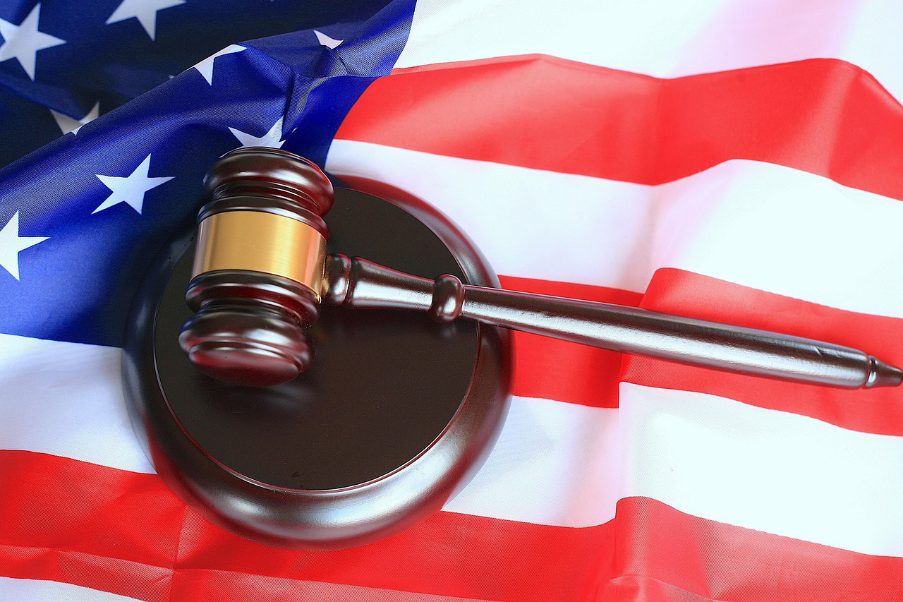 Brown wooden gavel on top of an American flag