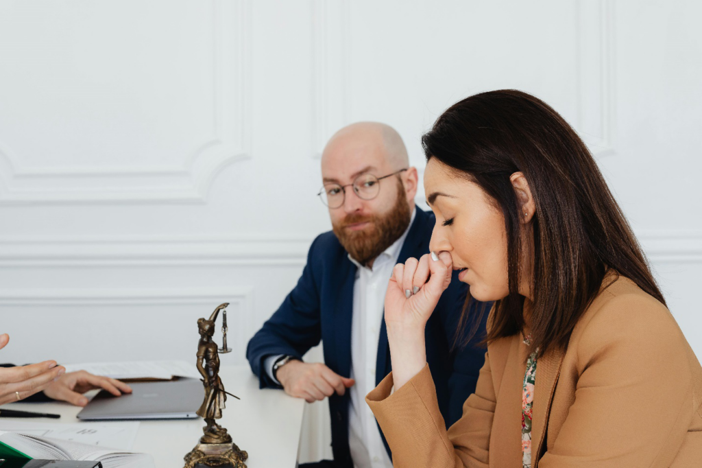 a woman crying while a man sitting next to her is looking at her