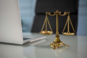 photo of gold colored balance next to a laptop
