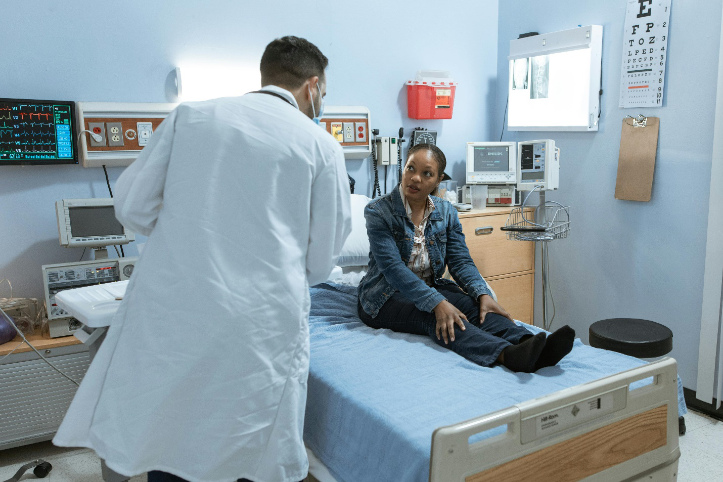 a patient on stretcher talking to a doctor