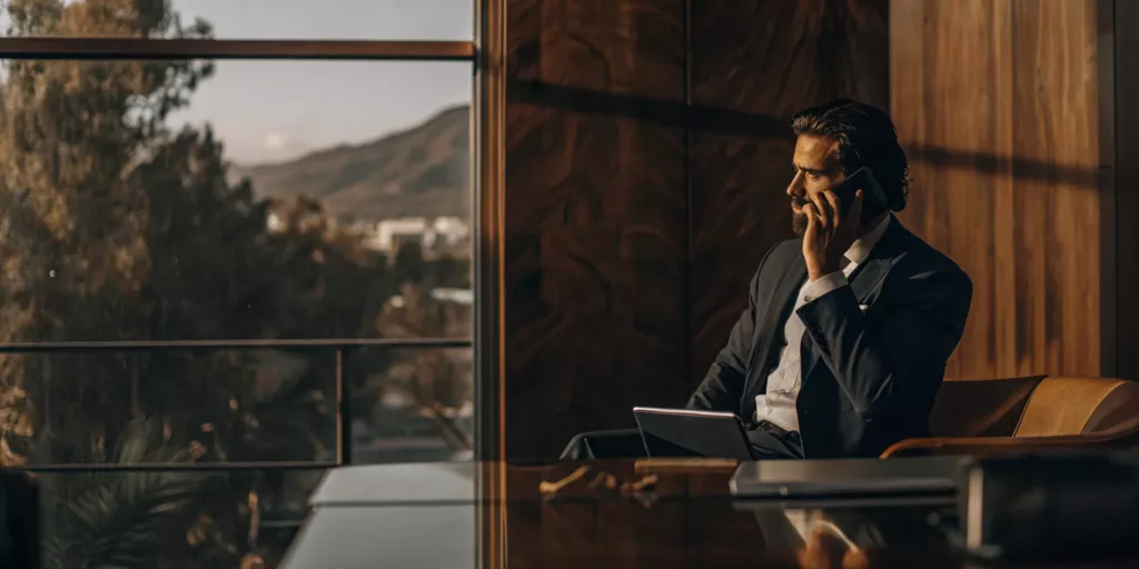 An Irvine car accident lawyer on the phone discussing a client's case.